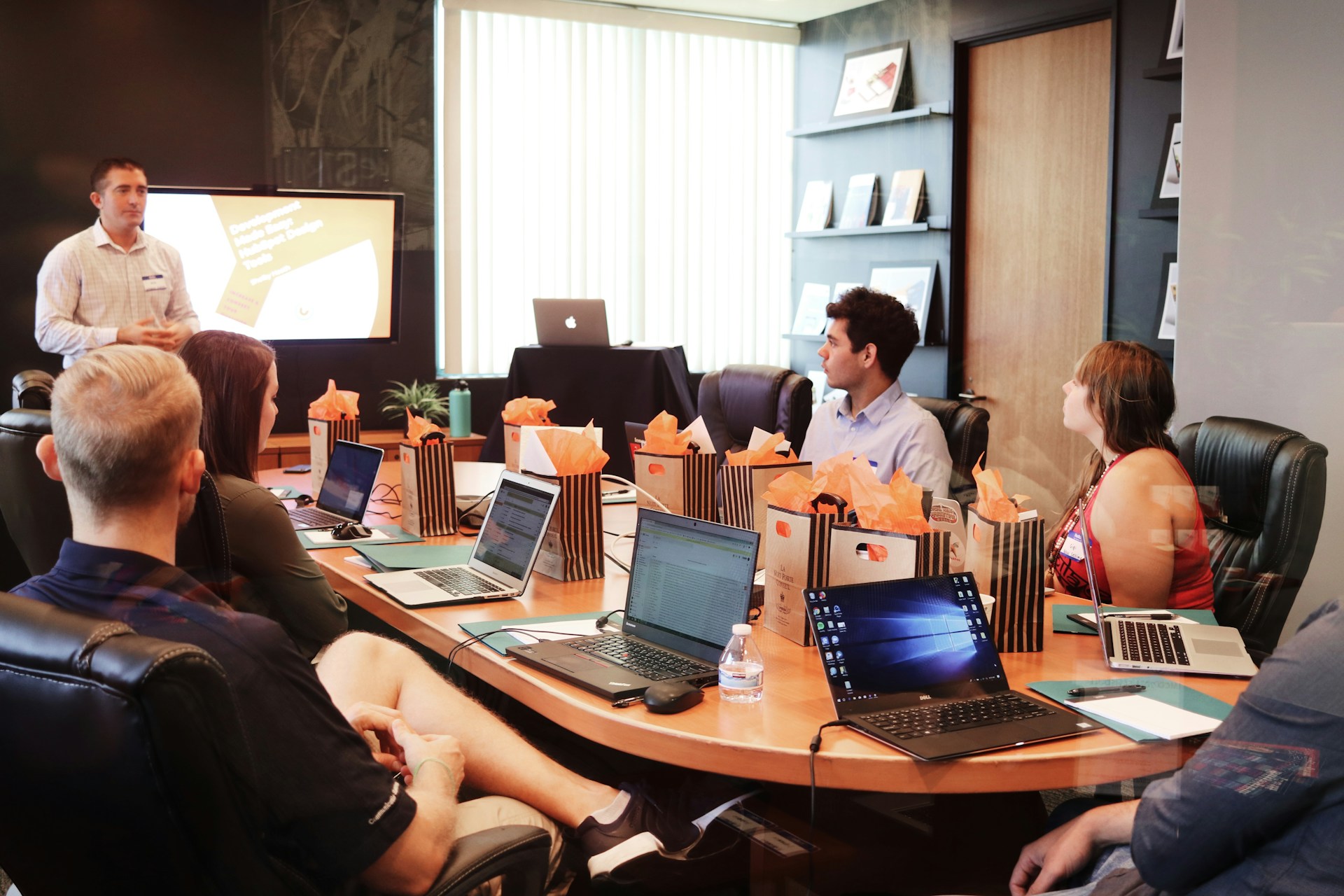 Professional workshop studio with laptops and planning materials on a long table